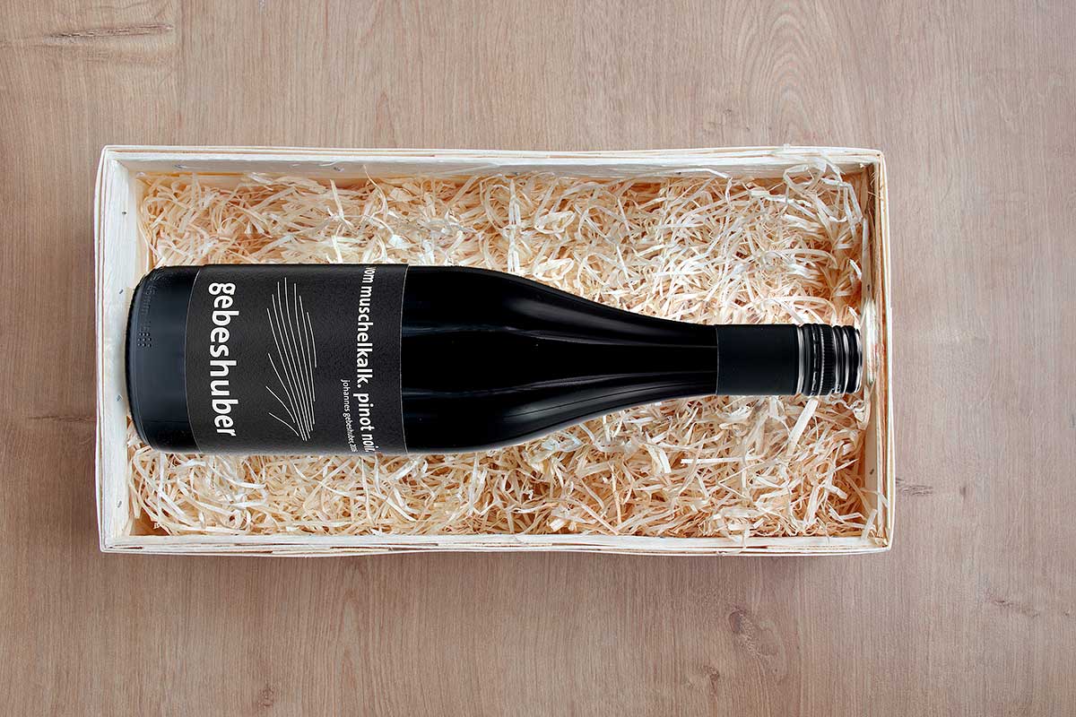 nominated-already-directly-above-shot-of-bottle-of-wine-in-wooden-box-with-straw-PINOT-NOIR